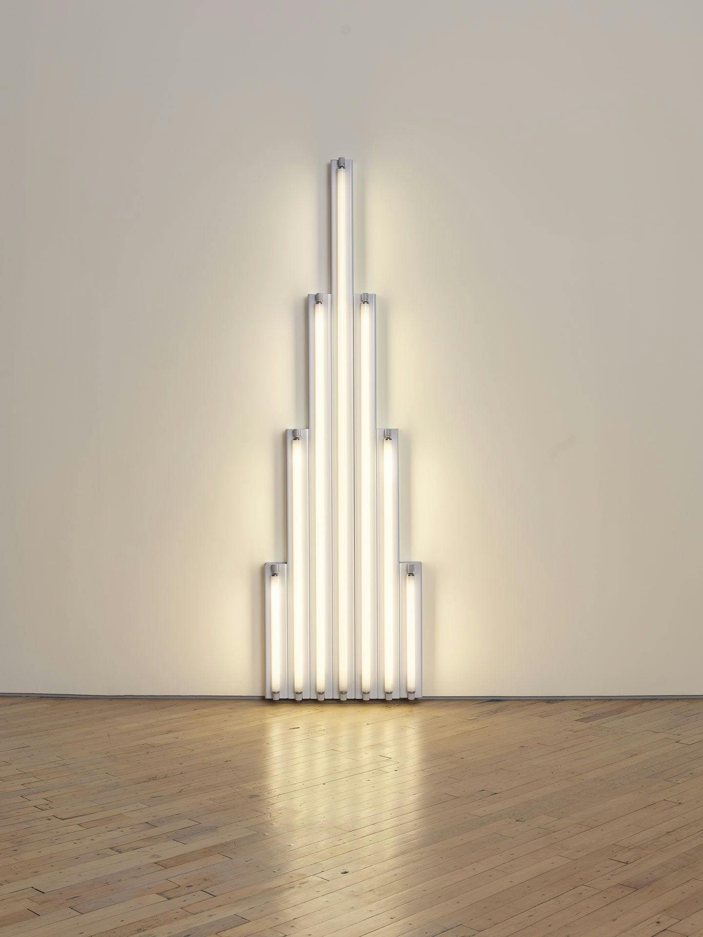 A sculpture in cool white fluorescent light by Dan Flavin, titled "monument" 1 for V. Tatlin, dated 1964.